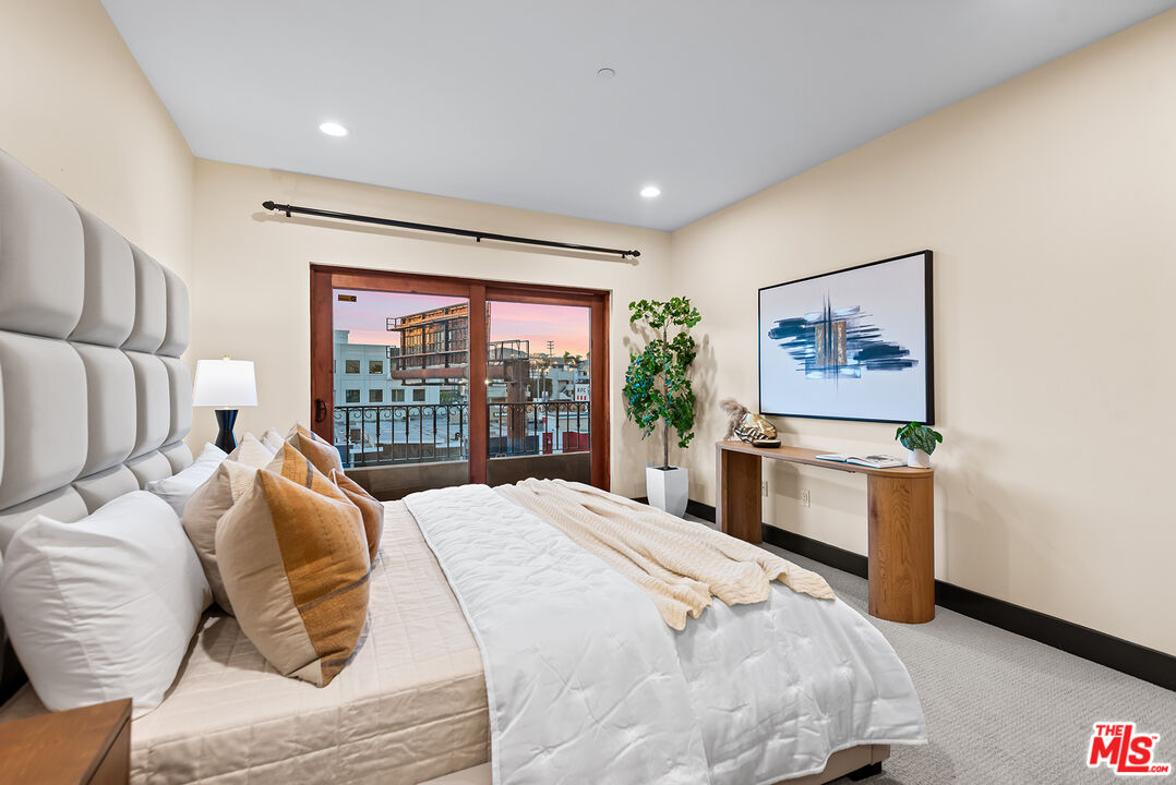 1215 Armacost Avenue, Unit 403 Los Angeles, CA 90025 - Photo 12 of 25 a bedroom with a bed and a large window