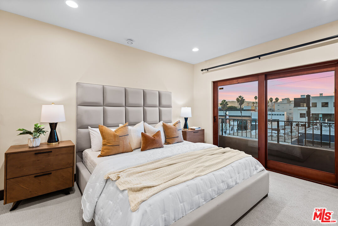 1215 Armacost Avenue, Unit 403 Los Angeles, CA 90025 - Photo 13 of 25 a bedroom with a large bed and a large window