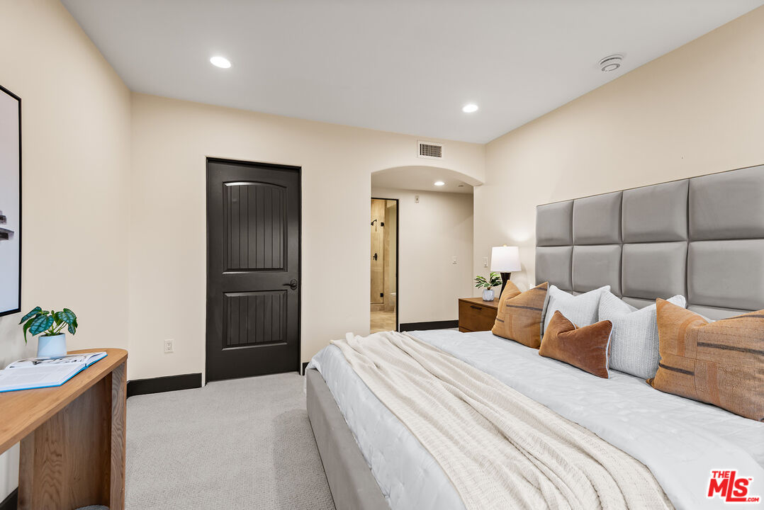 1215 Armacost Avenue, Unit 403 Los Angeles, CA 90025 - Photo 14 of 25 a bedroom with a bed and a potted plant