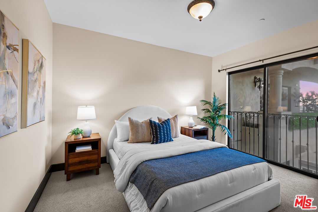 1215 Armacost Avenue, Unit 403 Los Angeles, CA 90025 - Photo 17 of 25 a bedroom with a bed and a lamp