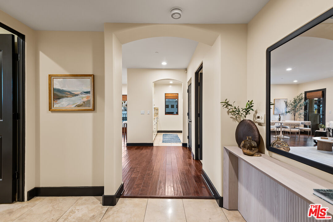 1215 Armacost Avenue, Unit 403 Los Angeles, CA 90025 - Photo 2 of 25 a view of a hallway view with wooden floor and furniture