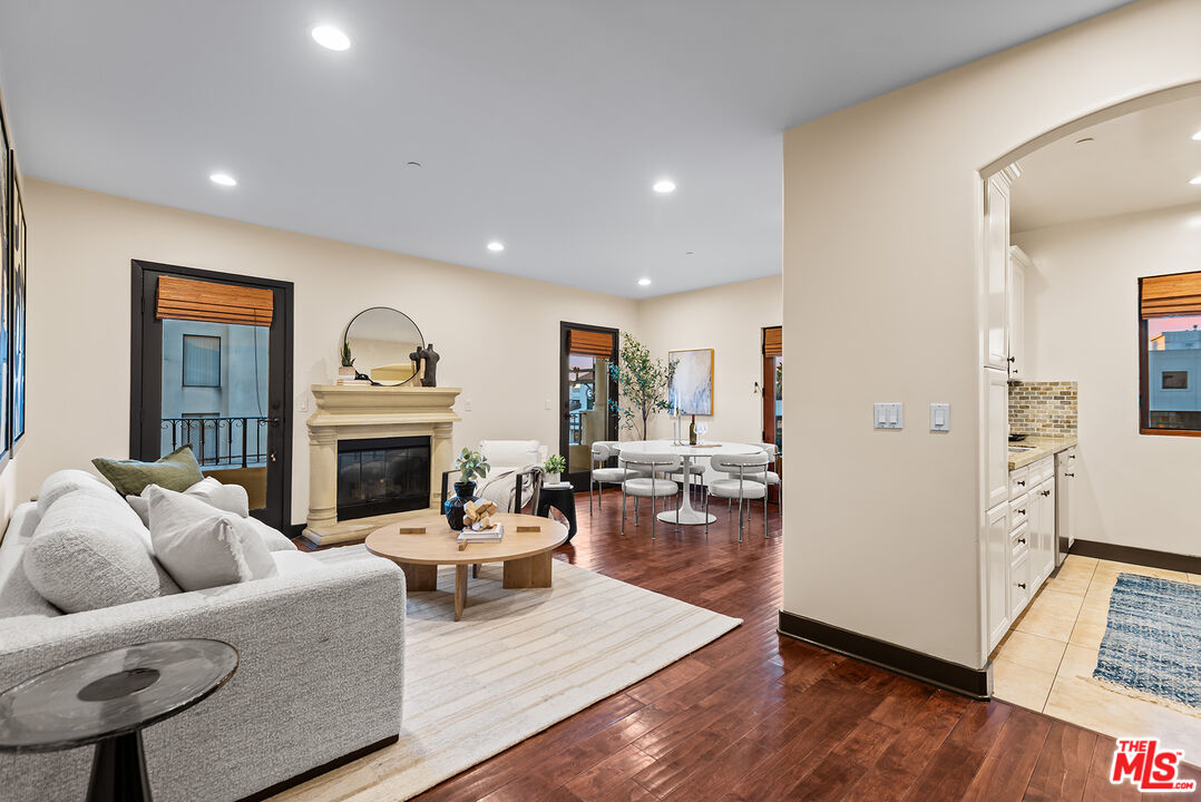 1215 Armacost Avenue, Unit 403 Los Angeles, CA 90025 - Photo 3 of 25 a living room with furniture and a fireplace