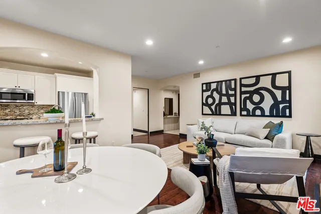 a living room with furniture and kitchen view
