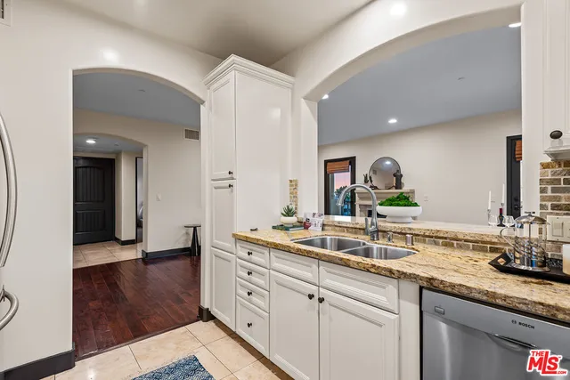 a spacious bathroom with double sink and a mirror