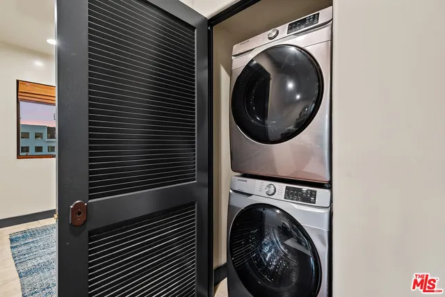 a view of a hallway with washer and dryer
