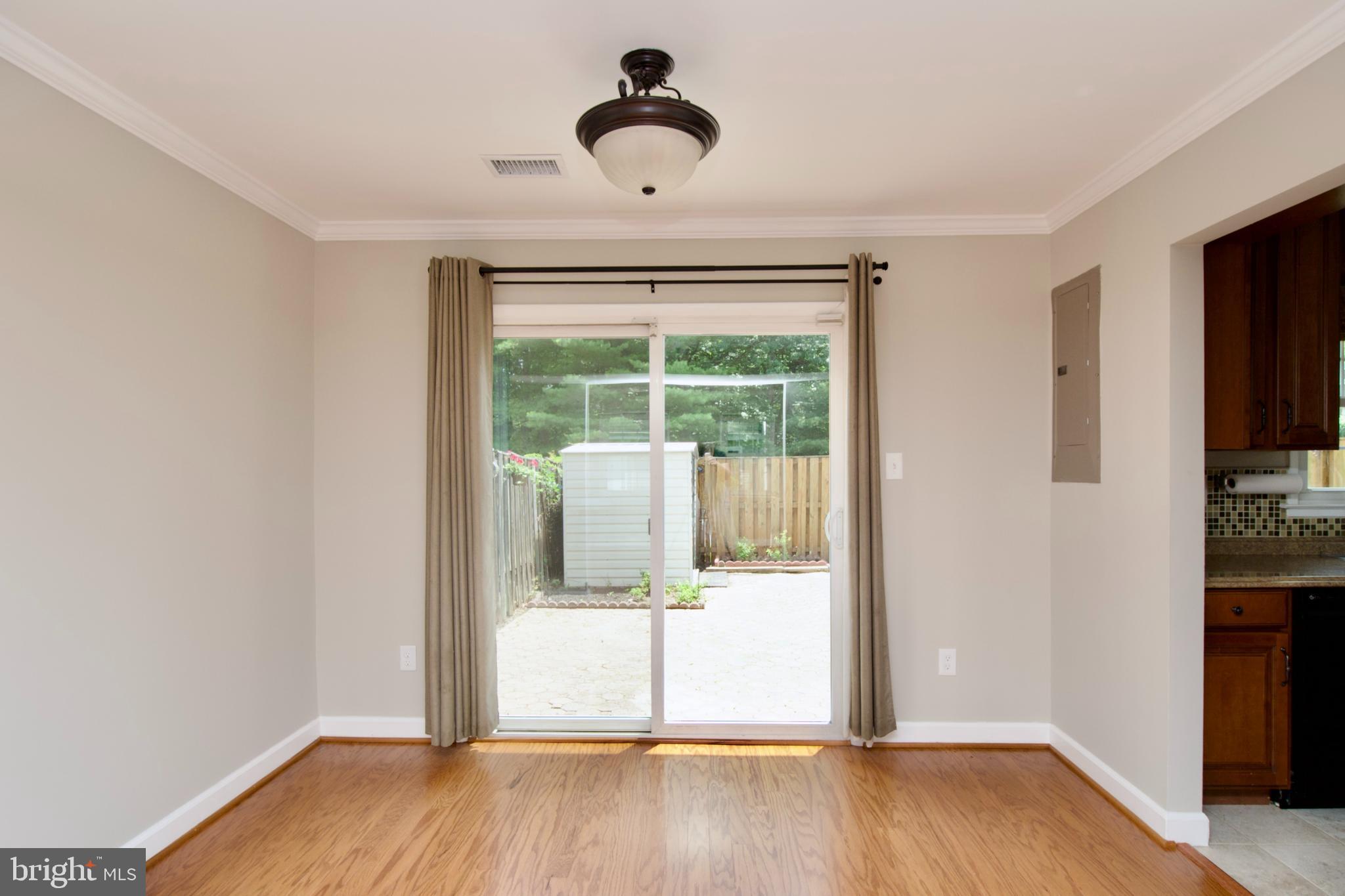 7726 Matisse Way Springfield, VA 22153 - Photo 11 of 34 a view of an empty room with wooden floor and a window