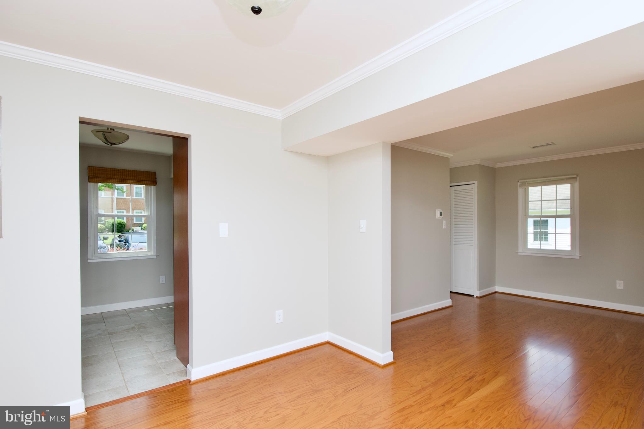 7726 Matisse Way Springfield, VA 22153 - Photo 12 of 34 an empty room with wooden floor and windows