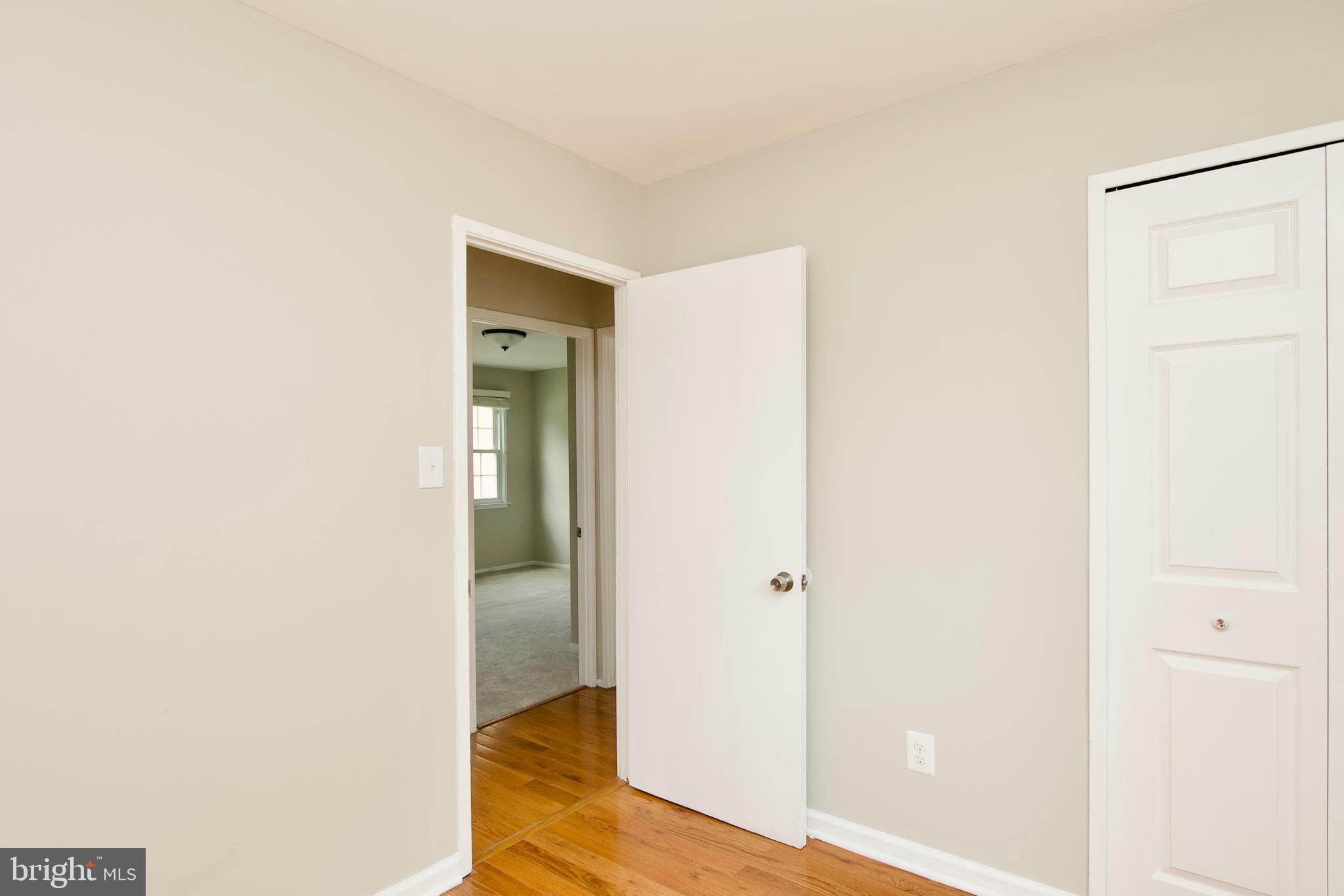7726 Matisse Way Springfield, VA 22153 - Photo 20 of 34 a view of a hallway with wooden floor