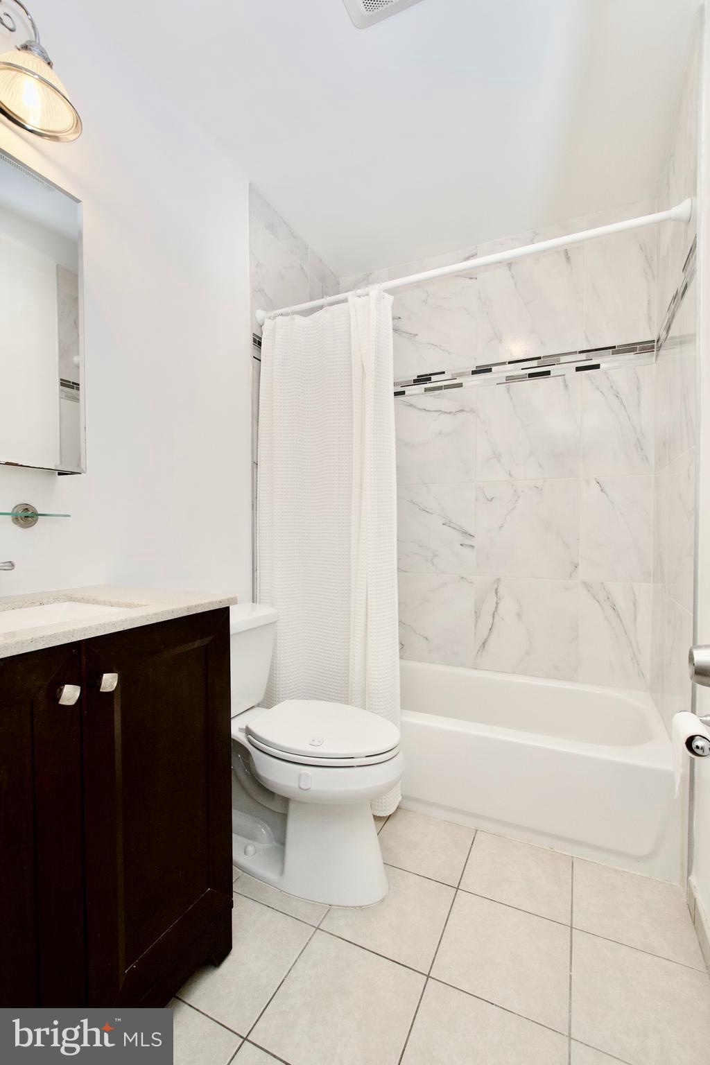 7726 Matisse Way Springfield, VA 22153 - Photo 21 of 34 a bathroom with a sink a toilet and shower