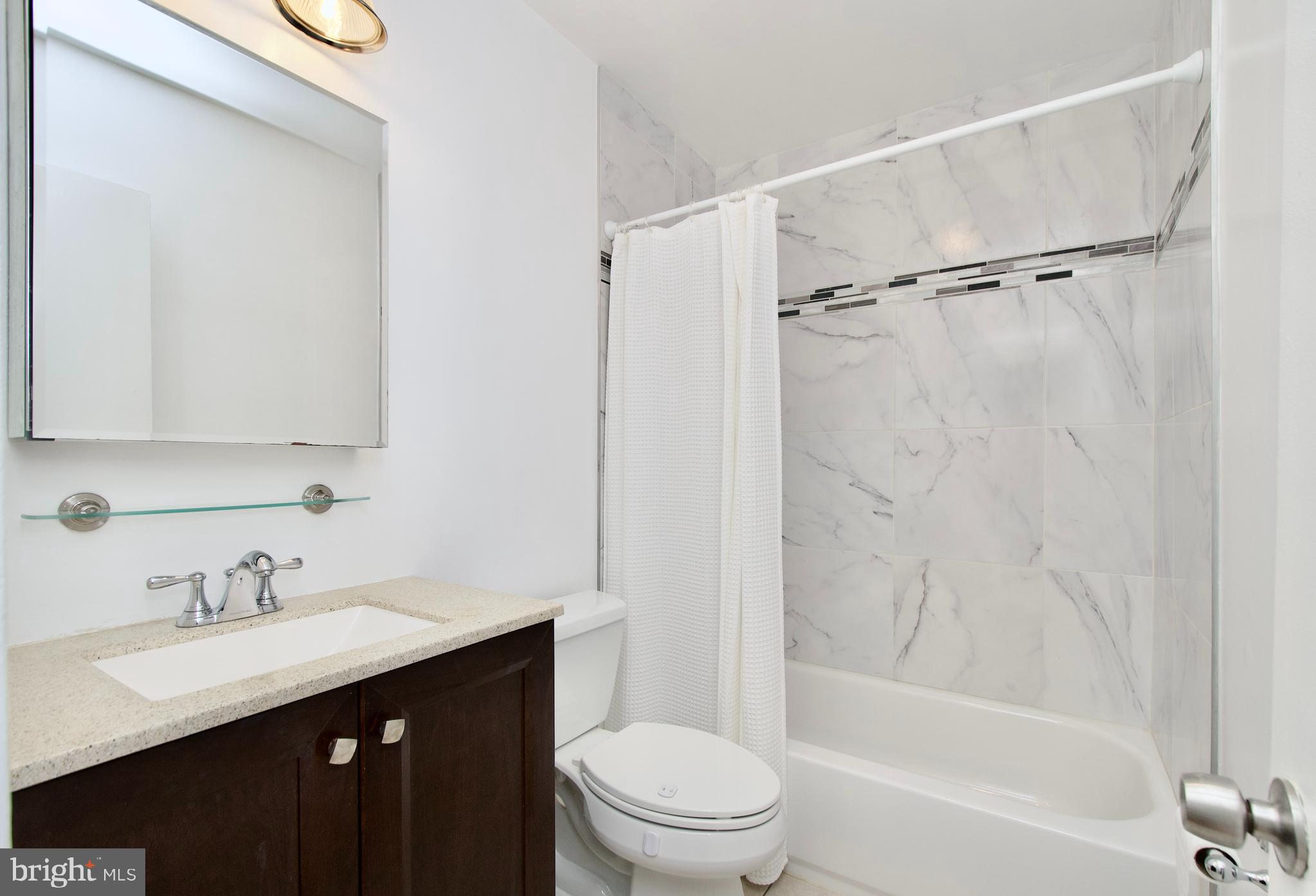 7726 Matisse Way Springfield, VA 22153 - Photo 22 of 34 a bathroom with a sink a toilet and shower