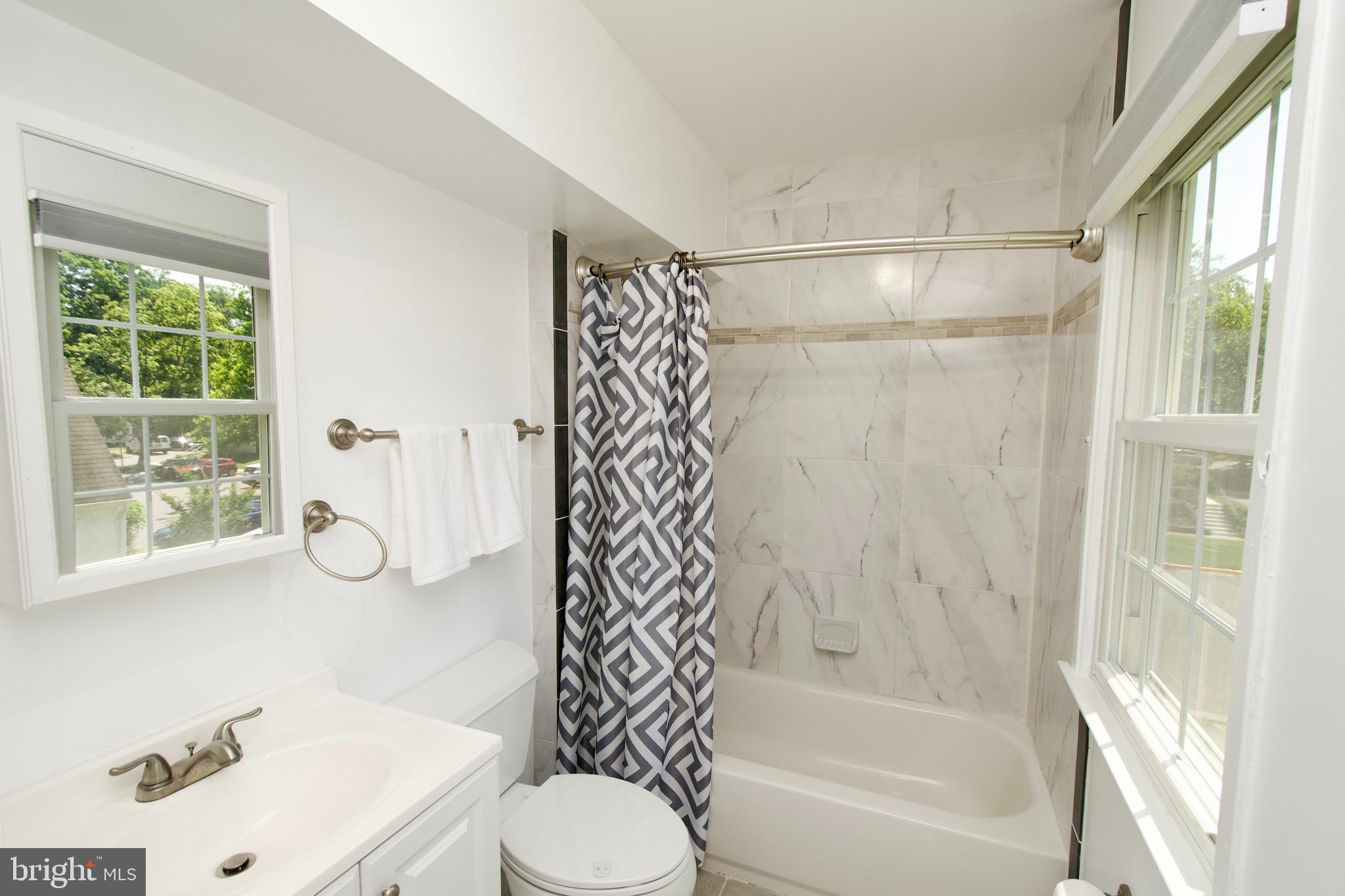 7726 Matisse Way Springfield, VA 22153 - Photo 27 of 34 a bathroom with a bathtub shower sink vanity and toilet