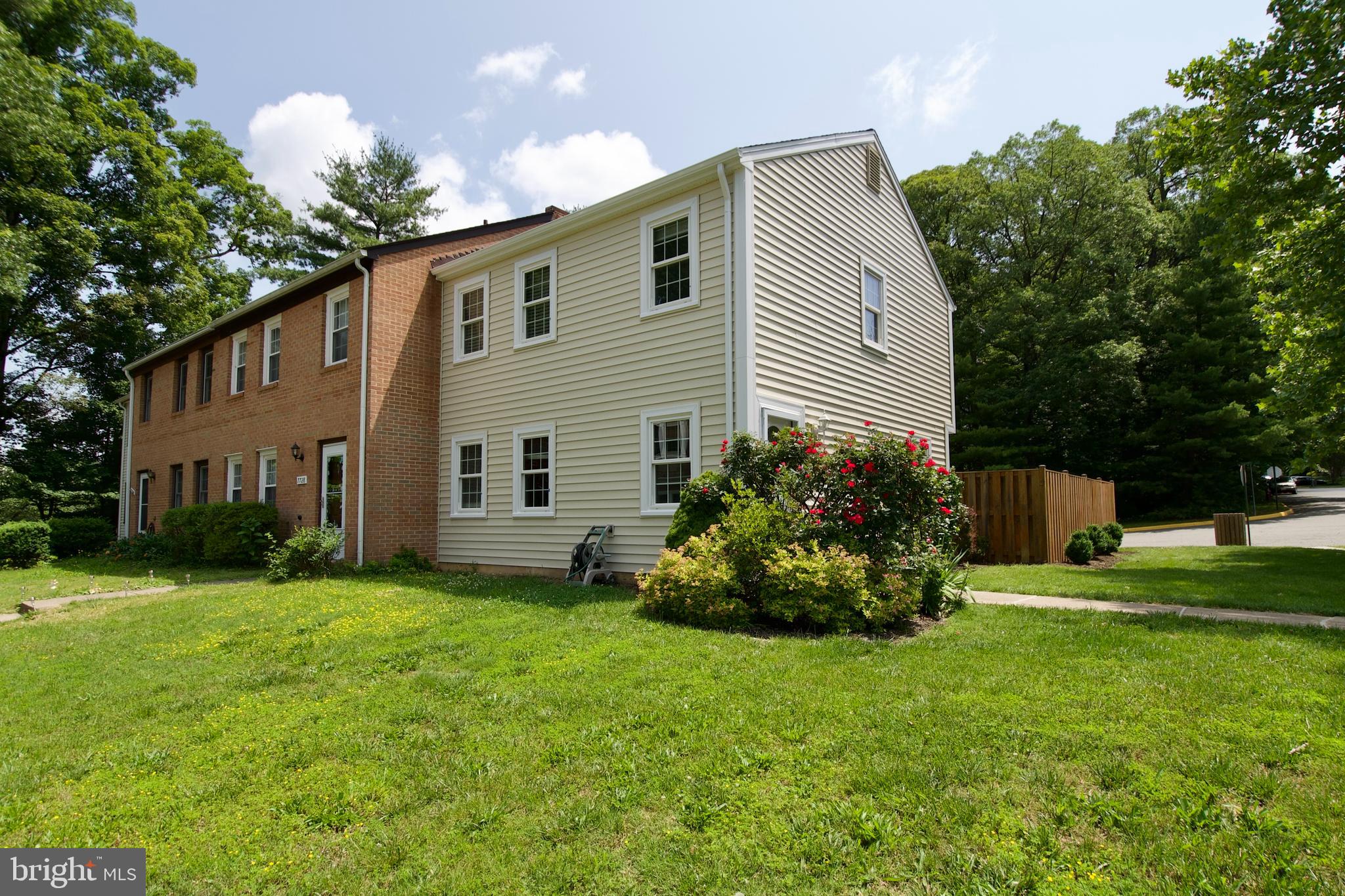 7726 Matisse Way Springfield, VA 22153 - Photo 3 of 34 a front view of a house with a garden