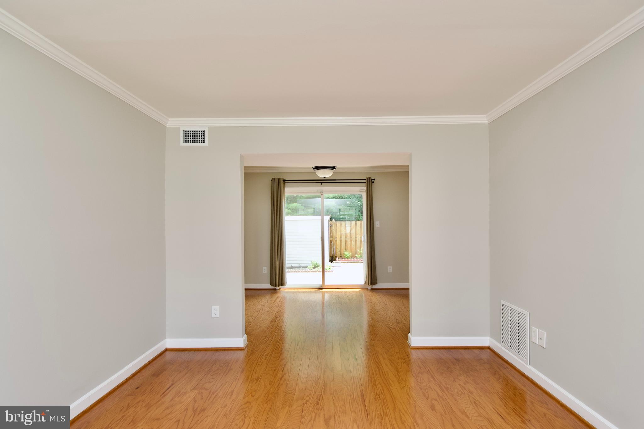 7726 Matisse Way Springfield, VA 22153 - Photo 6 of 34 a view of an empty room with wooden floor