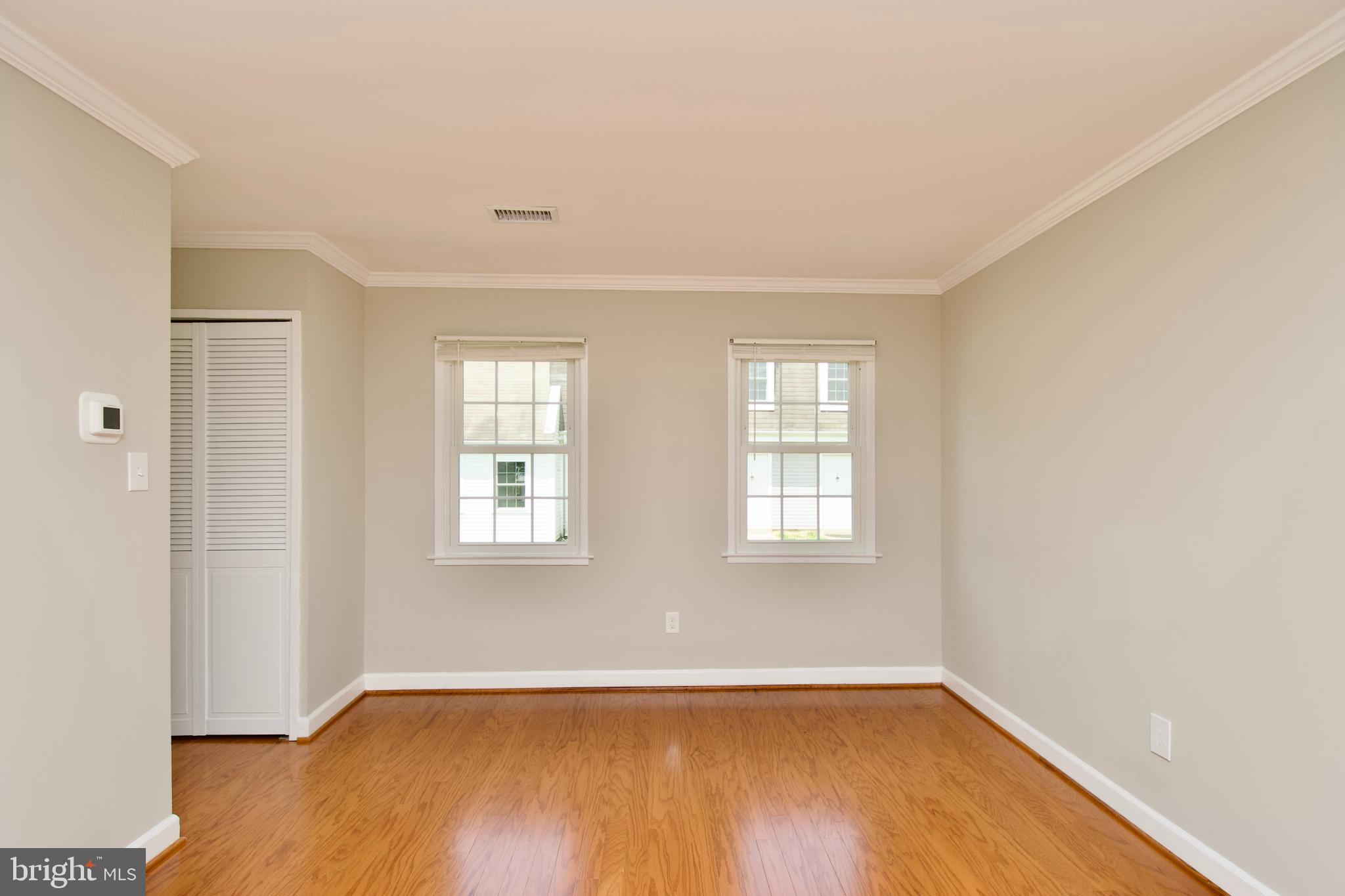 7726 Matisse Way Springfield, VA 22153 - Photo 9 of 34 an empty room with wooden floor and windows