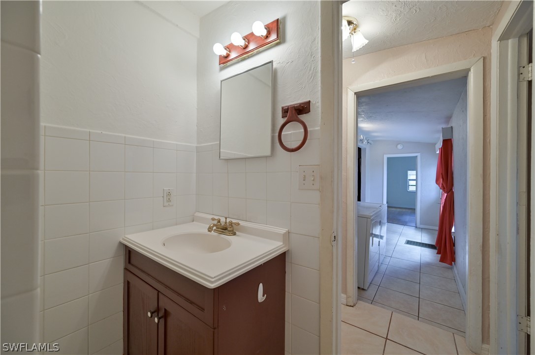 8500 Judeth Lane Estero, FL 33928 - Photo 16 of 19 a bathroom with a sink and a mirror