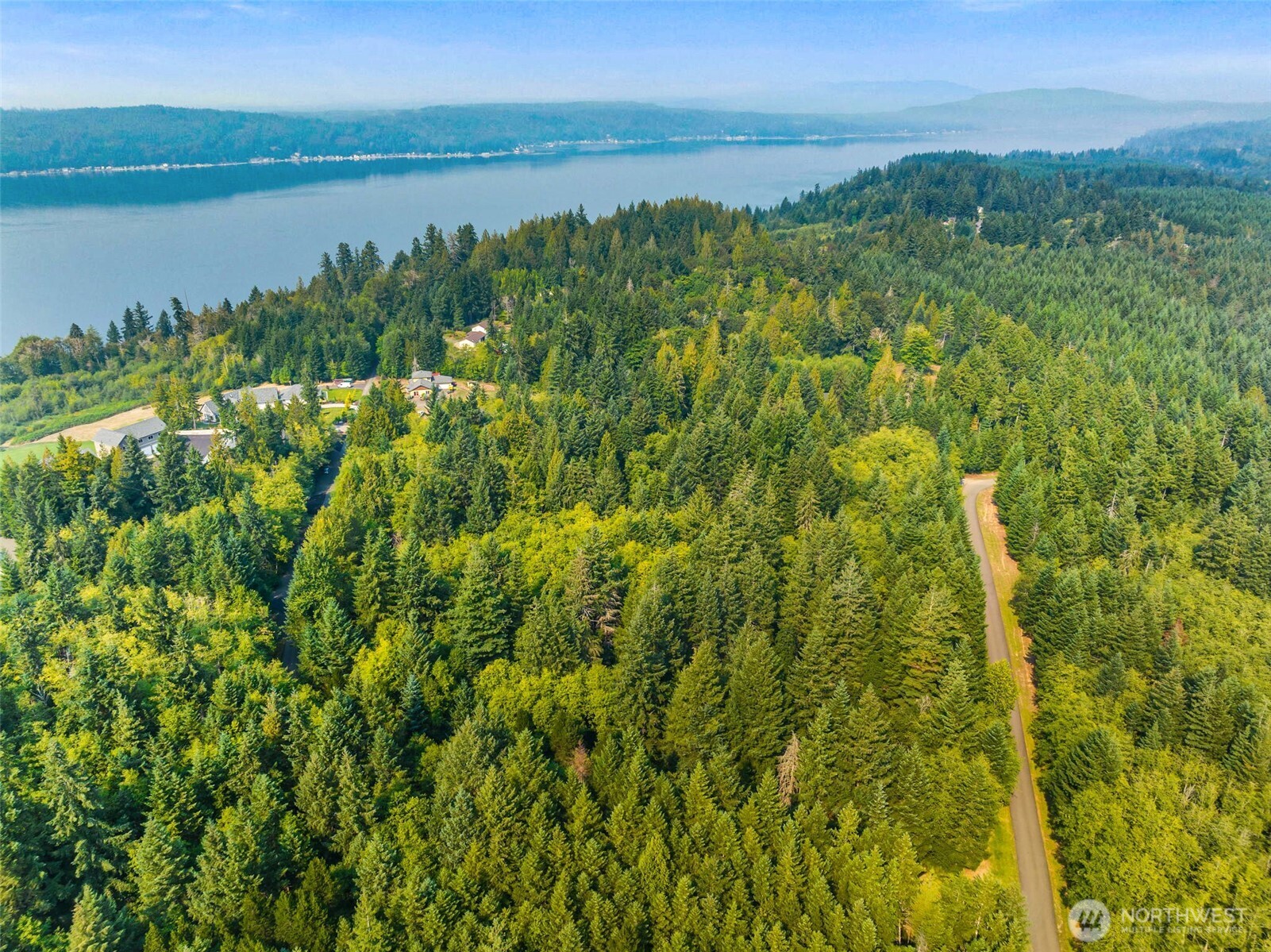 70 East Windy Ridge Lane Belfair, WA 98528 - Photo 5 of 9 a view of a green field with a lake view