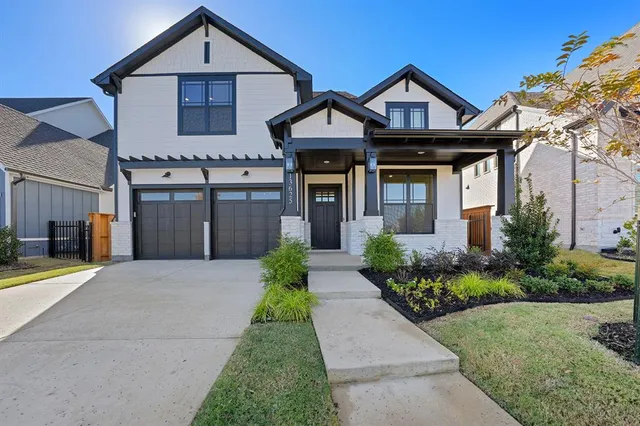 a front view of a house with a garden and plants