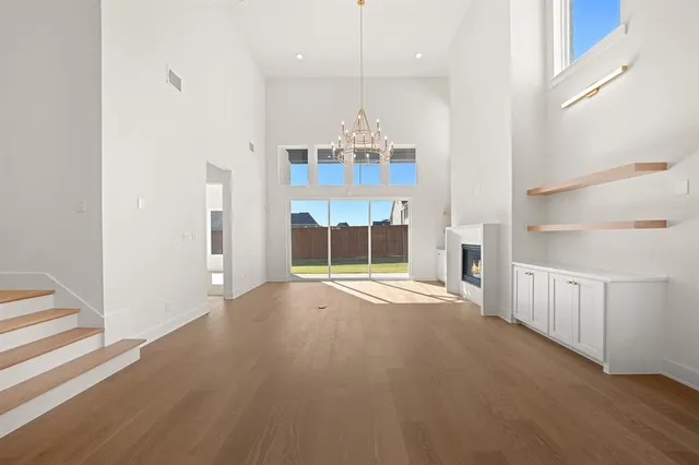 a view of a room with a window and chandelier