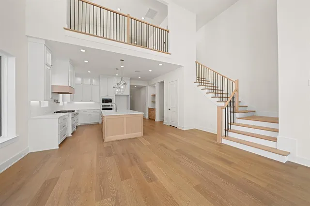 a view of kitchen with wooden floor and electronic appliances