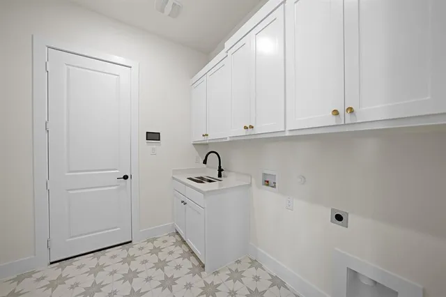 a view of a kitchen with white cabinets