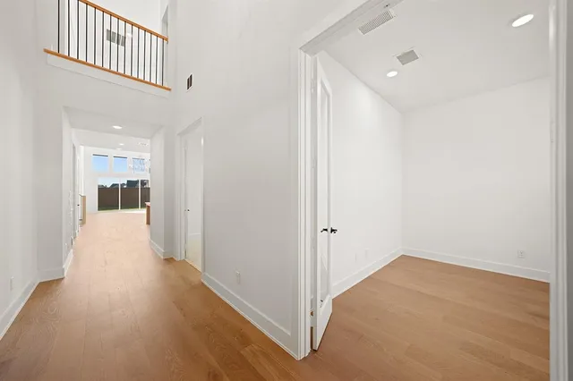 a view of hallway with wooden floor
