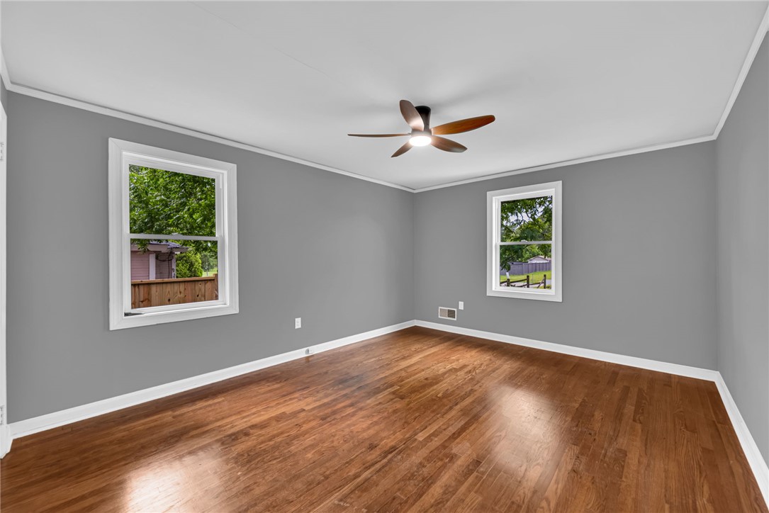 1010 Log Shoals Road Mauldin, SC 29662 - Photo 17 of 28 Hardwood floors and a ceiling fan create a comfortable and inviting atmosphere in this bedroom.