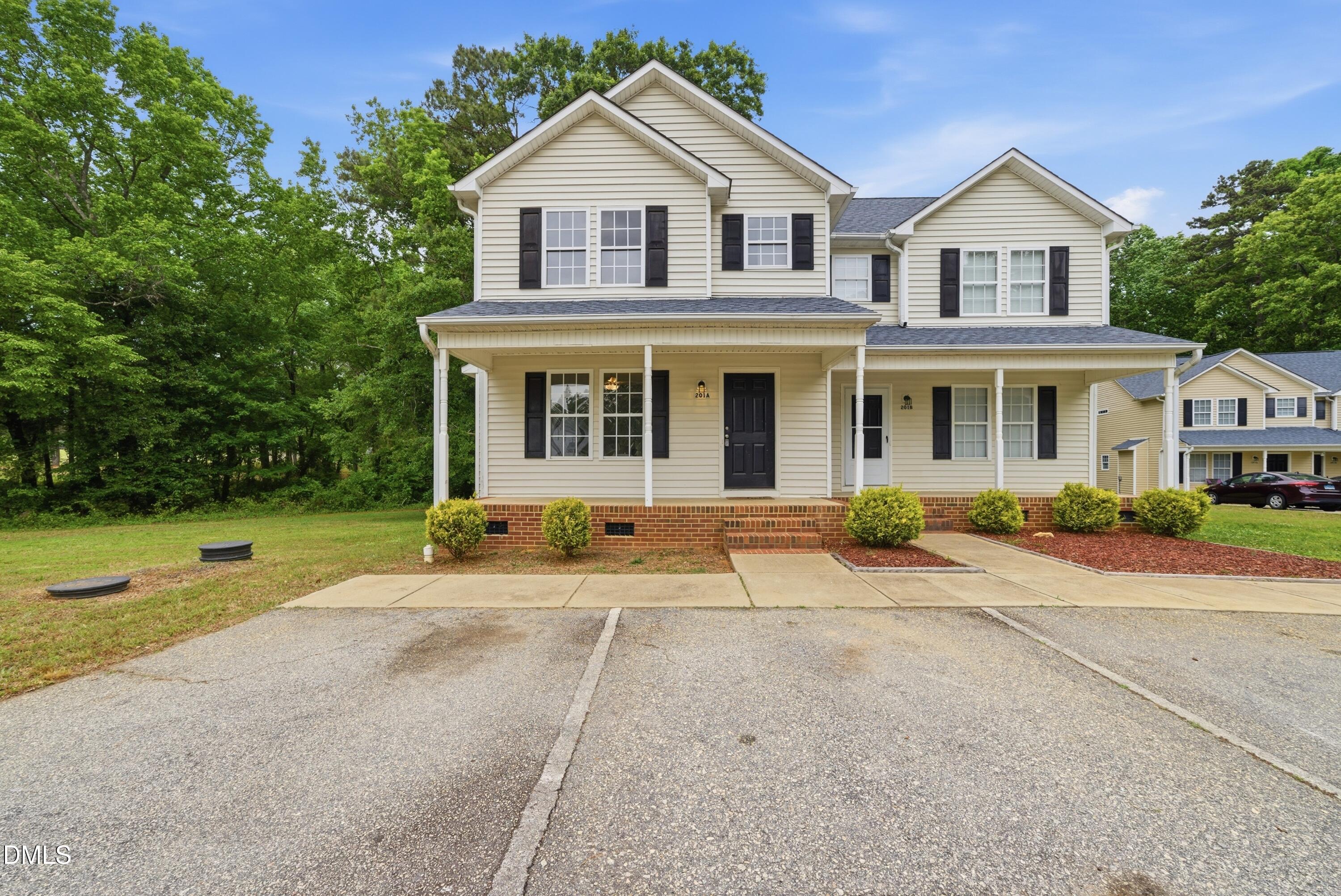 201 Tonylee Court, Unit A Raleigh, NC 27603 - Photo 1 of 30 a front view of a house with a yard and garage