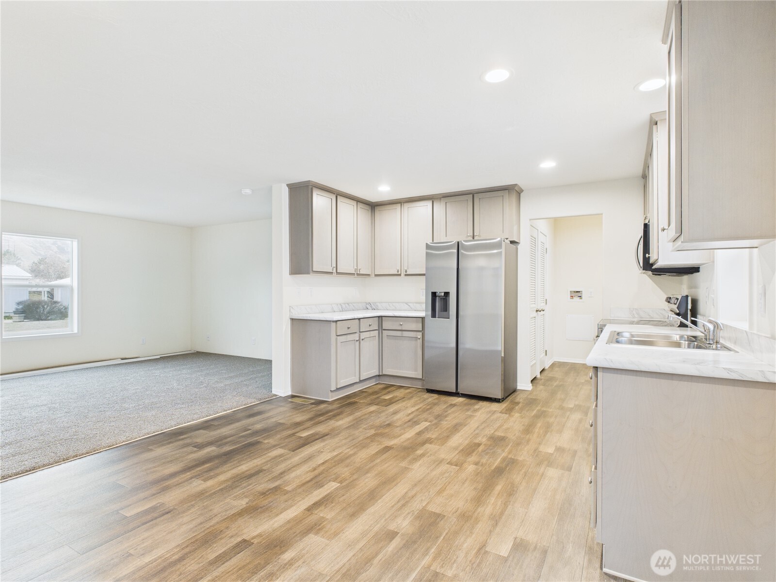 401 2nd Street Southwest Rock Island, WA 98850 - Photo 5 of 12 a kitchen with stainless steel appliances a sink and a refrigerator