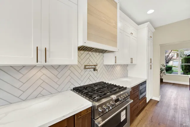 a view of hallway with wooden floor and window
