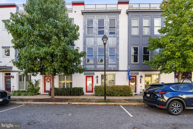 a front view of a residential apartment building with a yard