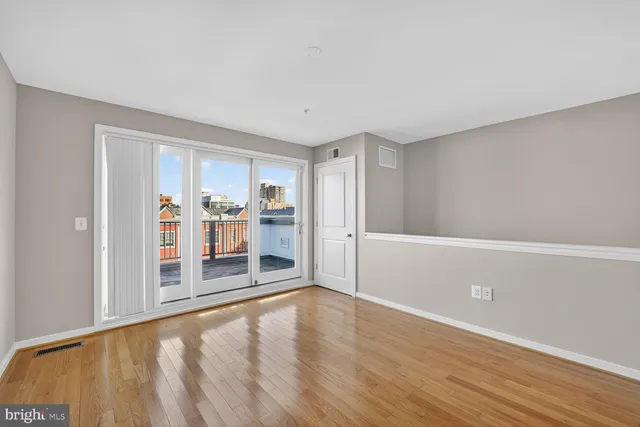 a view of a livingroom with wooden floor and a window