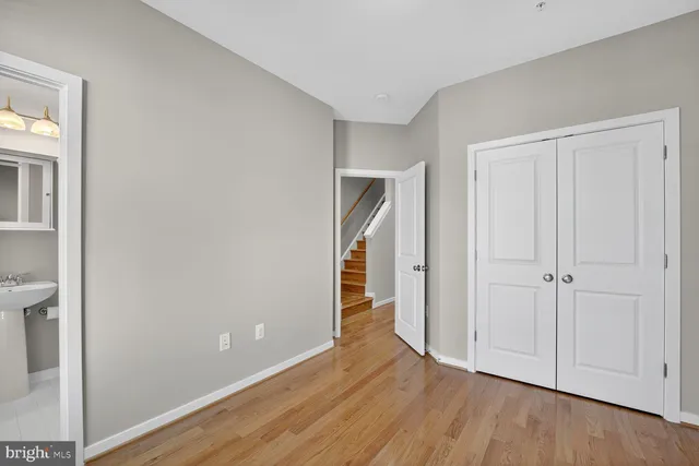 a view of a livingroom with wooden floor and closet area