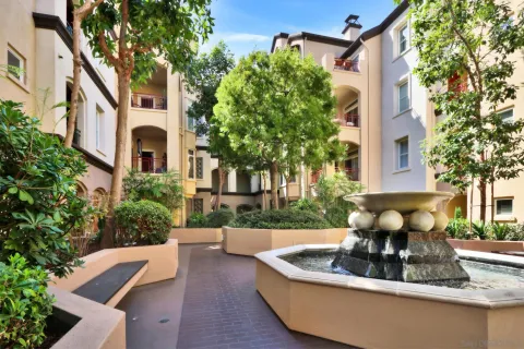 a view of a building with a yard and sitting area