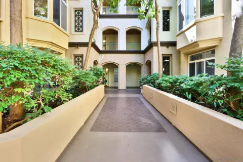 a view of a white building with a outdoor space