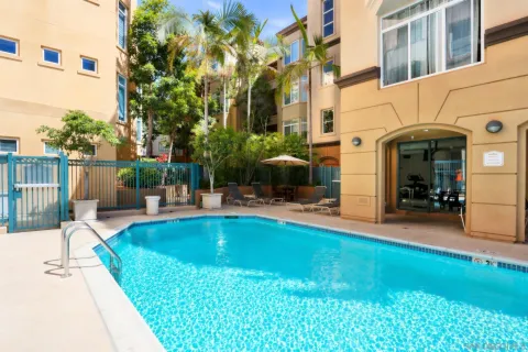 a view of a patio with couches table and chairs and potted plants