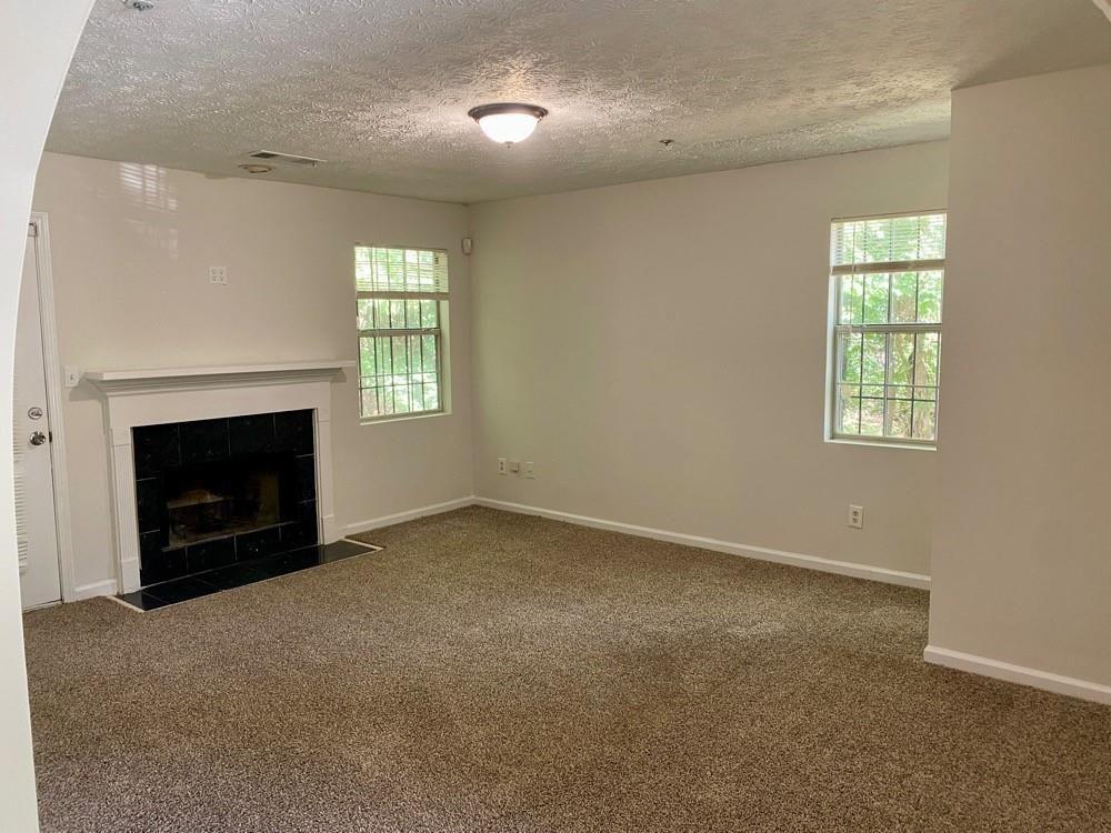 3763 Soapstone Road Decatur, GA 30034 - Photo 3 of 10 an empty room with a fireplace and window