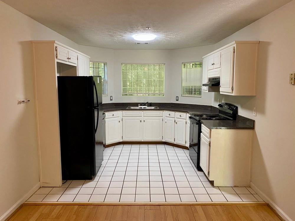 3763 Soapstone Road Decatur, GA 30034 - Photo 4 of 10 a kitchen with a sink a refrigerator and cabinets