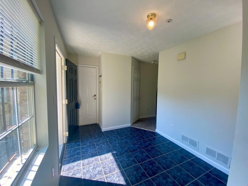 3763 Soapstone Road Decatur, GA 30034 - Photo 10 of 10 an empty room with wooden floor and windows