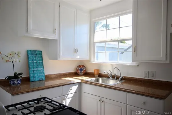 a kitchen with stainless steel appliances a sink a stove and a window