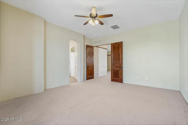 a spacious bathroom with a double vanity sink and a large mirror