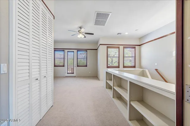 an aerial view of a house with a yard and mountain