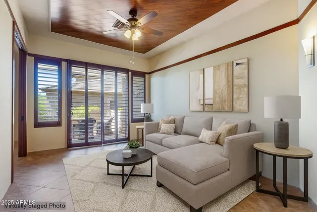 a living room with furniture and a potted plant