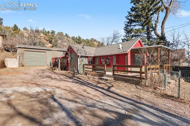 a view of a house with wooden fence