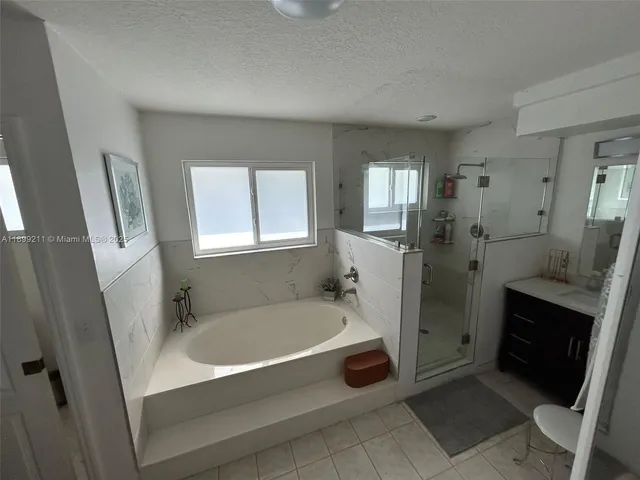 a bathroom with a tub sink and window