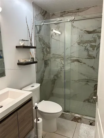 a bathroom with a toilet sink and shower