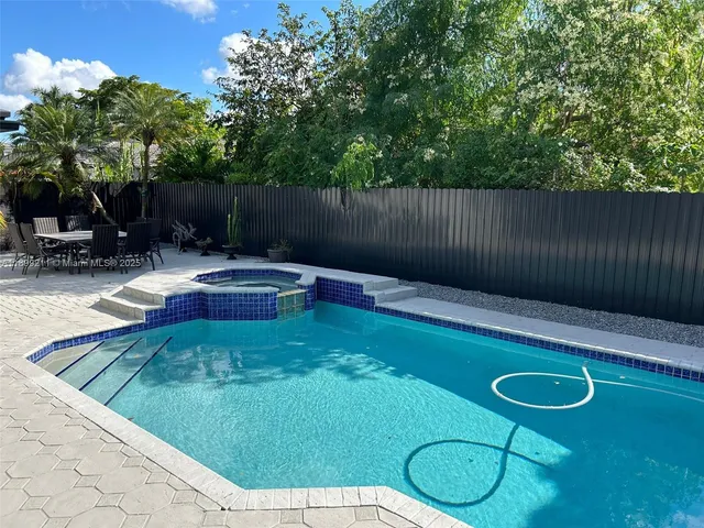 a backyard of a house with table and chairs