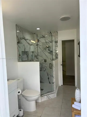 a bathroom with a toilet and a shower