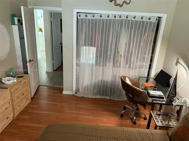 a view of a workspace with furniture and a bathroom