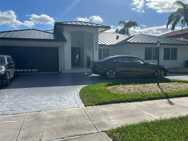 a front view of a house with a yard and a garage