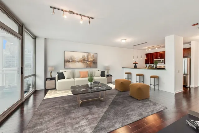 a living room with furniture and a wooden floor